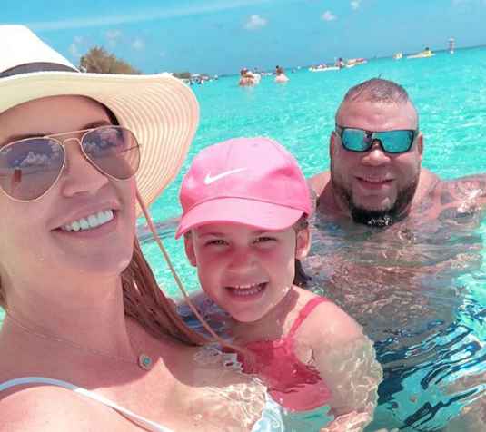 George Murdoch with his girlfriend and daughter enjoying holiday.